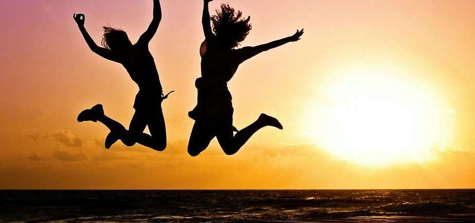 silhouette photography of jump shot of two persons